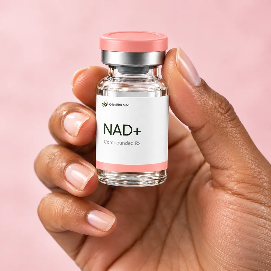 Hand holding an illustrative OliveBird Med NAD+ vial